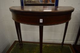 A mahogany and satinwood banded demi-lune fold-over card table.