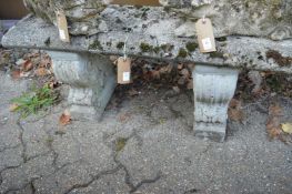 A reconstituted stone garden bench.