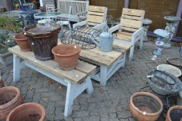 A chunky pine and painted pine garden set comprising pair of armchairs, two tiered table and bench