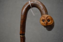 A good carved walking stick, the handle formed as the head of an owl and a mouse.