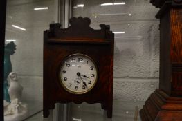 A small oak mantel clock.