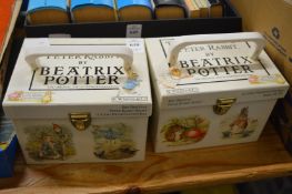 Two boxed sets of Beatrix Potter books.