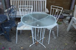 White painted wrought iron circular glass top table with pair of chairs.