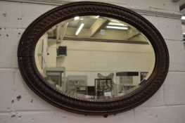 An oval wall mirror.