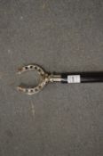 Walking stick, the chrome plated handle modelled as a horseshoe.