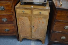 A small mahogany two door cupboard.
