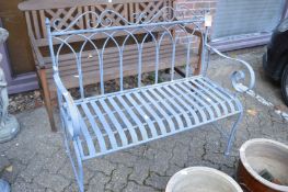 A wrought iron garden bench.