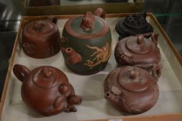 A collection of six Chinese yixing teapots.