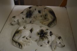 A pair of Staffordshire recumbent dogs.