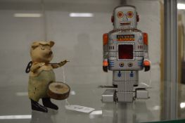 A Schuco clockwork drumming pig and a Japanese clockwork robot.