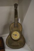 A small guitar shaped table clock.