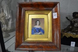 Portrait miniature of a young lady wearing a blue dress.