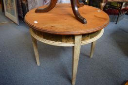 A decoratively painted pine top circular table with printed frieze depicting birds and fruit.