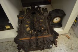 A cuckoo clock and a small slate mantel clock.