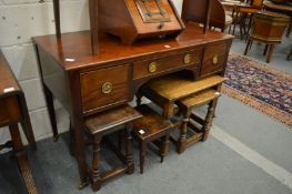 A mahogany three drawer side table or sideboard.