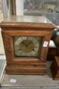 An oak cased mantel clock.