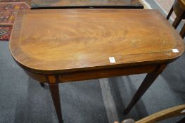 A 19th century mahogany and inlaid D shaped fold-over card table.