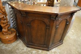 A carved oak drinks bar.