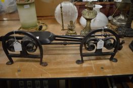 Wrought iron fire dogs and fireside tools.