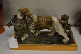 A painted spelter table lighter modelled as a spaniel and cock pheasant.