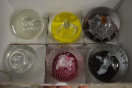 Six glass paperweights.