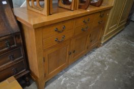 A large modern oak sideboard.
