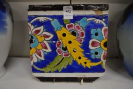 A glazed pottery tile.