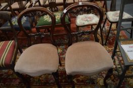 A pair of Victorian style mahogany dining chairs.