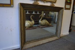 A large rectangular mirror with heavy moulded frame.