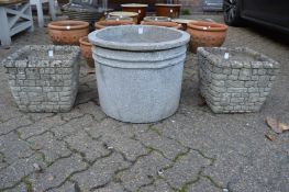 A pair of reconstituted stone planters and a concrete planter.