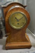 A mahogany balloon shaped mantel clock.