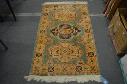 A modern green ground Persian style rug, 150cm x 92cm.