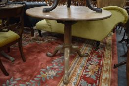 A 19th century mahogany circular tilt-top bird cage tripod table.