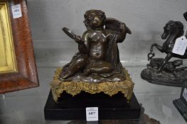 A 19th century bronze of a seated putti holding a mirror.