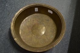 An Islamic engraved brass circular bowl.