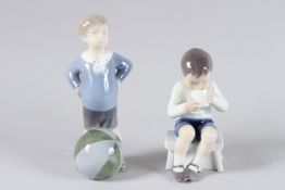 TWO ROYAL COPENHAGEN PORCELAIN FIGURES OF A YOUNG BOY. Nos. 416 and 3542. 5ins and 6.5ins high.