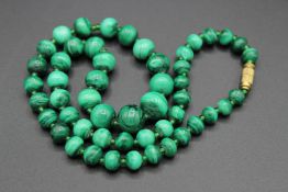A MALACHITE BEAD NECKLACE. 20ins long.