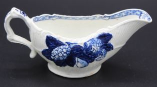 A SMALL DERBY RIBBED BLUE AND WHITE SAUCEBOAT 1760, with flowers. 4.5ins long. Provenance:MERCURY