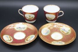 TWO PAIRS OF LANDSCAPE GILT CUPS AND SAUCERS.