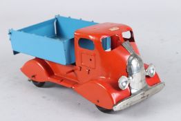 A TRI-ANG RED AND BLUE TIP UP TRUCK. 25cms long.