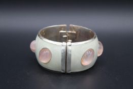 A SILVER, ENAMEL AND MOONSTONE BRACELET. Signed.