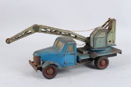 A TINPLATE LORRY WITH CRANE. 40cms long.