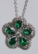 AN 18CT WHITE GOLD, EMERALD AND DIAMOND PENDANT AND CHAIN.