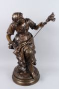 MARCEL DEBUT 1865 - 1833. A BRONZE OF A YOUNG GIRL seated, holding a stick with birds. Signed, on