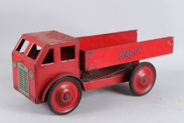 A RED TIP UP TIN PLATE LORRY. 50cms long.