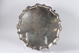 AN ELKINGTON & CO. SILVER PIE CRUST SALVER on four knop feet. 16ins diameter. Birmingham 1935.