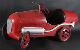 A TRI-ANG RED PEDAL CAR. 110cms long.