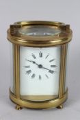 A FRENCH BRASS OVAL CARRIAGE CLOCK. 4.5ins high.