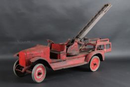 A LARGE TINPLATE FIRE ENGINE with ladder. 72cms long.