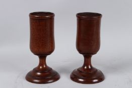 A GOOD PAIR OF TREEN WINE CUPS. 6.5ins high.